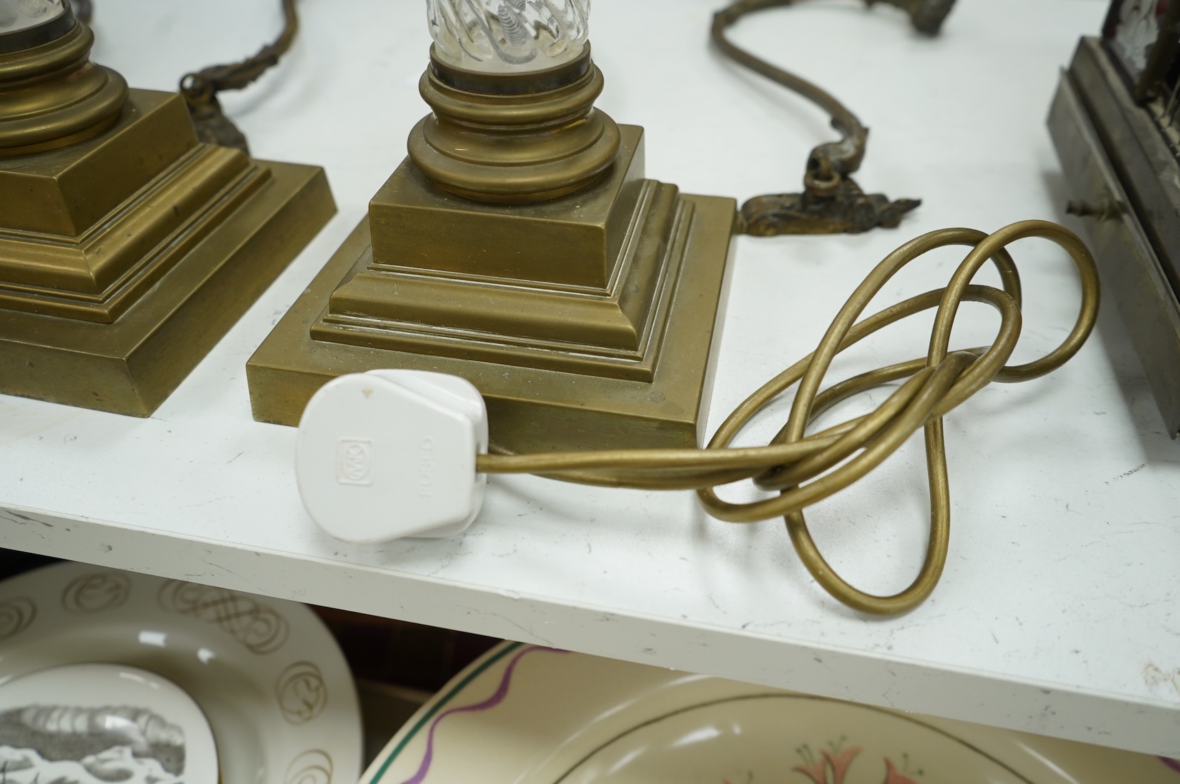 A pair of brass and glass Corinthian column lamps, 59cm high overall